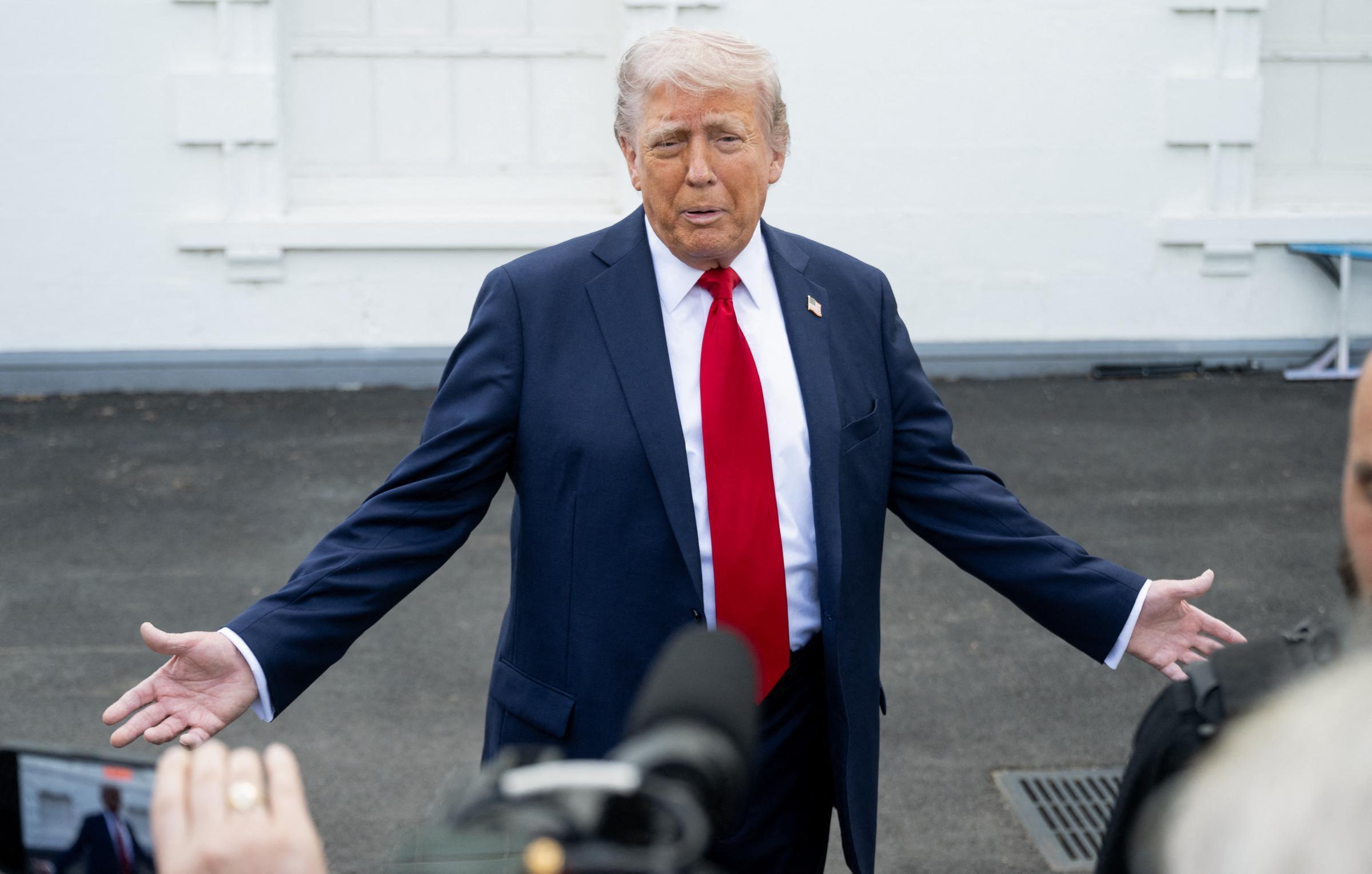 President Donald Trumptalks to reporters outside the White House in Washington, DC, on April 23, 2025 | Source: Getty Images