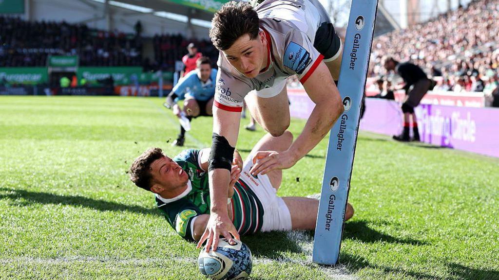 Angus Hall of Saracens scores over Leicester's Adam Radwan